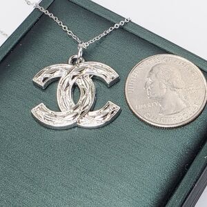 CHANEL Silver Logo Pendant Necklace